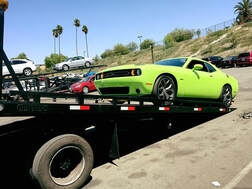 Picture of an exotic car being hauled by a tow truck in San Diego, California.